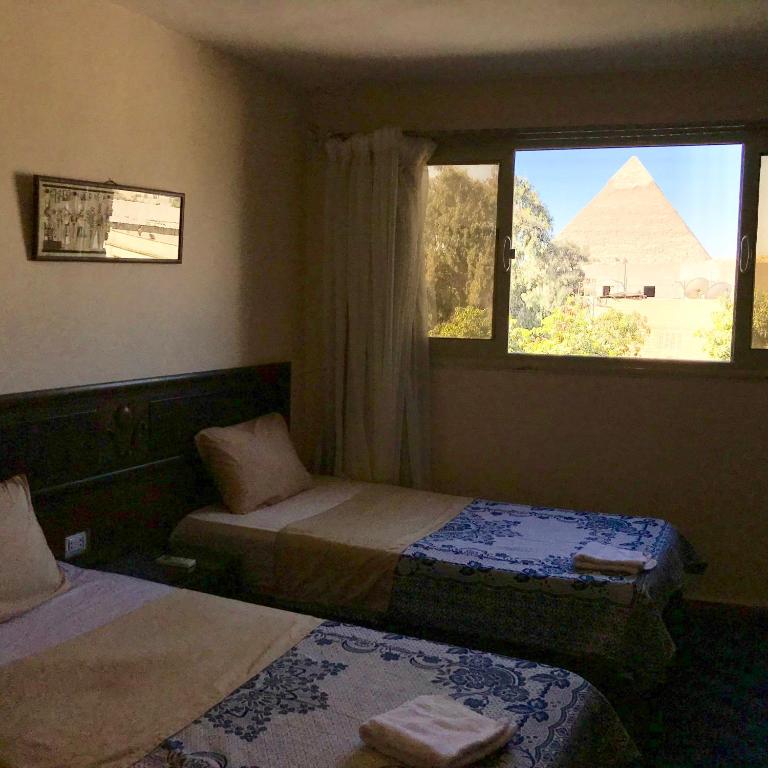 Двухместный (Двухместный номер Делюкс с 1 кроватью или 2 отдельными кроватями, вид на пирамиды) отеля 3 Pyramids View Inn, Каир