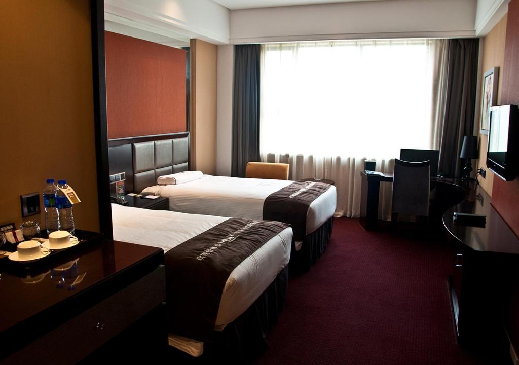 Двухместный (Двухместный номер Делюкс с 2 отдельными кроватями) отеля Shanghai New Century Manju Hotel Luoshan @SNIEC, Шанхай