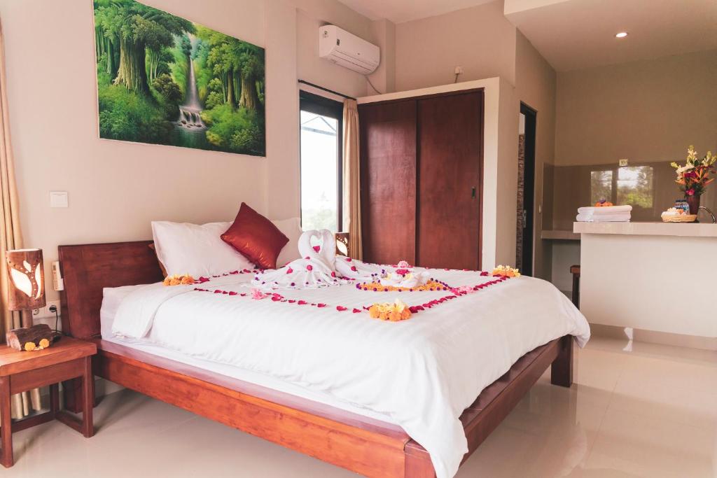 Двухместный (Двухместный номер Делюкс с 1 кроватью и балконом), Umah Tikari Guesthouse