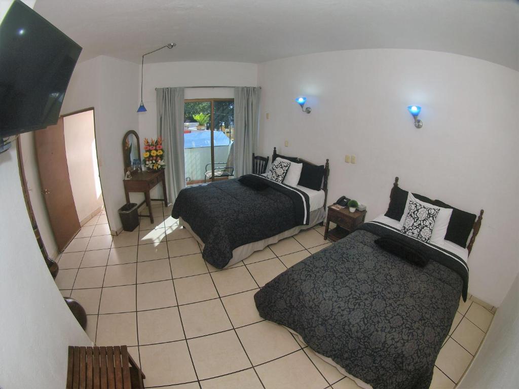 Двухместный (Deluxe  Double Room with Two Double Bed) отеля Hotel Hospedajes Del Rey, Колима