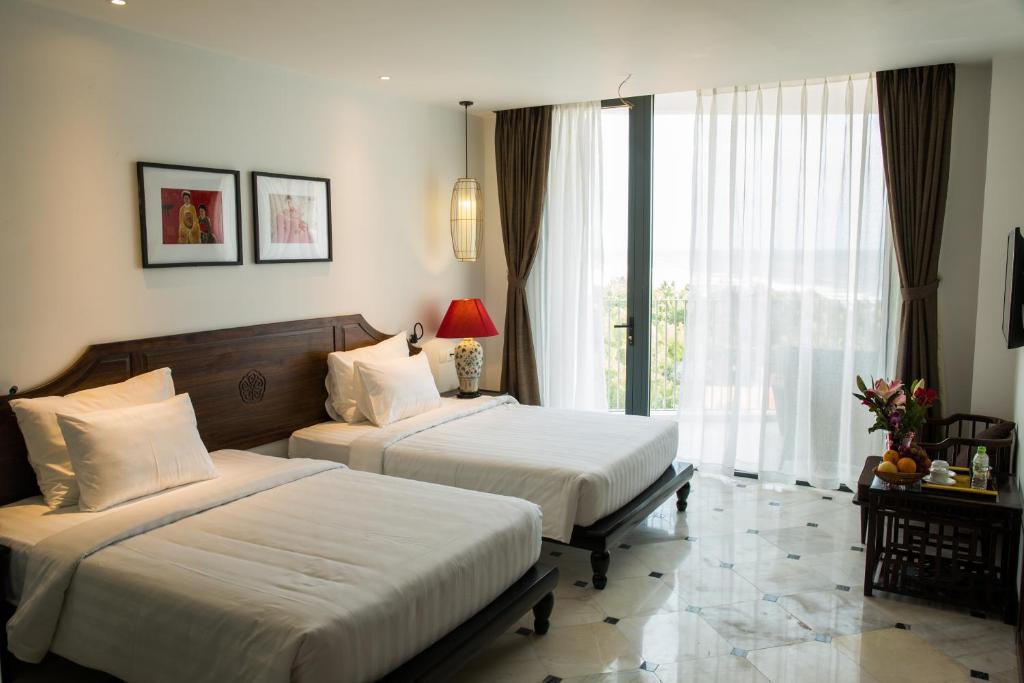 Двухместный (Двухместный номер Делюкс с 1 кроватью или 2 отдельными кроватями и видом на море) курортного отеля The Palmy Phu Quoc Resort & Spa, Дуонг-Донг