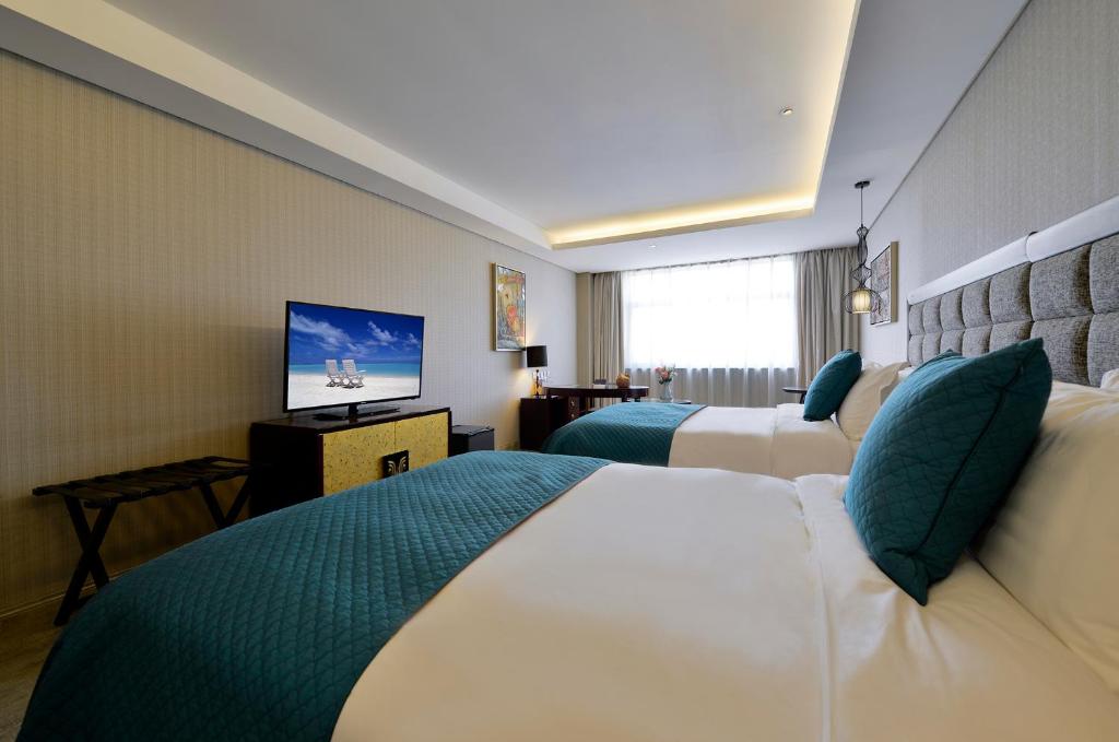 Двухместный (Улучшенный двухместный номер с 2 отдельными кроватями) отеля Merlinhod Hotel Xi'an (Formerly Meihua-Goldentang , Сиань