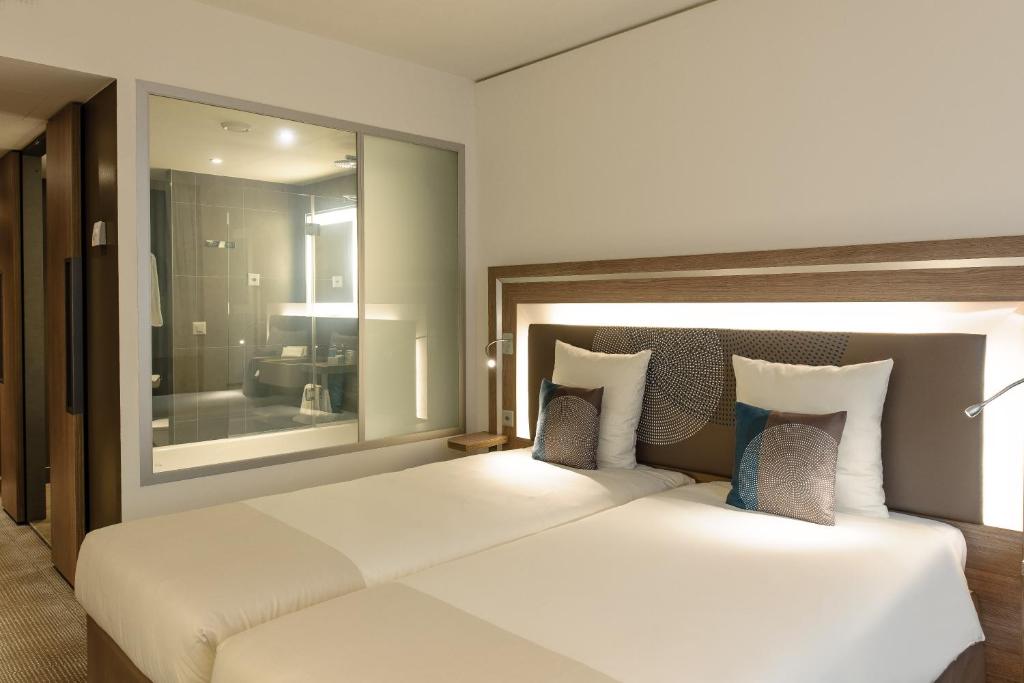 Двухместный (Улучшенный двухместный номер с 2 отдельными кроватями) отеля Novotel Lugano Paradiso, Лугано