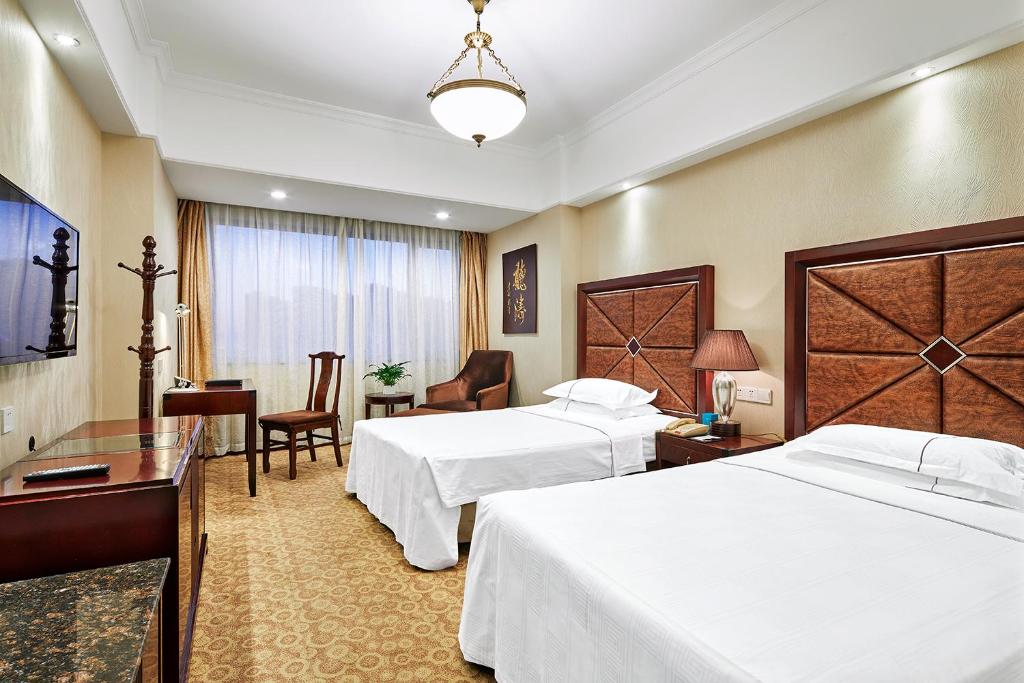 Двухместный (Улучшенный двухместный номер с 2 отдельными кроватями) отеля Grand Regency Hotel, Циндао