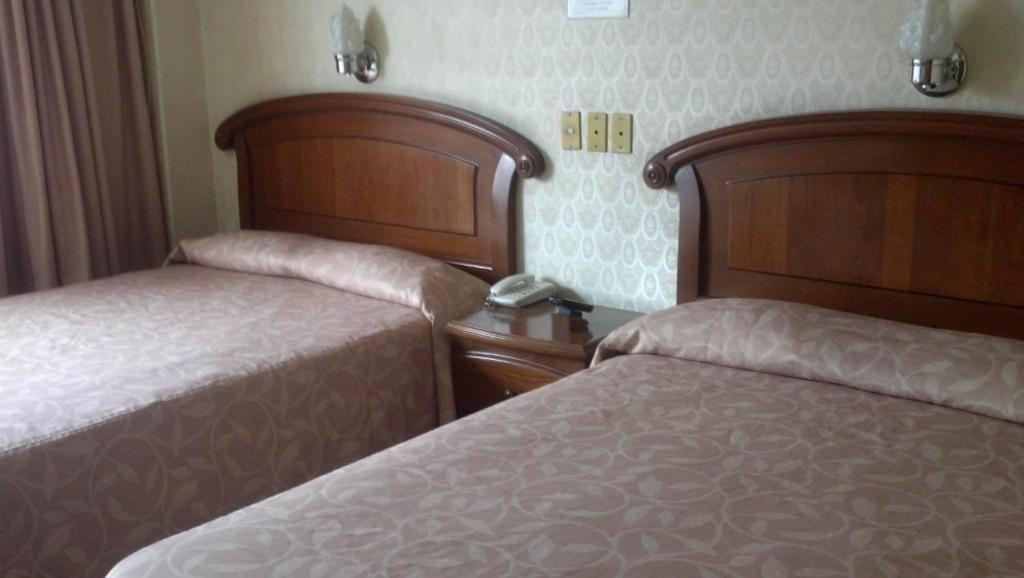 Двухместный (Двухместный номер с 2 двуспальными кроватями) отеля Nuevo Hotel Alameda de Uruapan, Уруапан