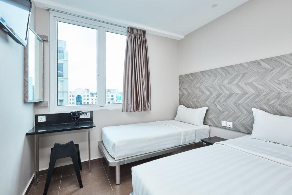Двухместный (Двухместный номер Делюкс с 2 отдельными кроватями) отеля Fragrance Hotel - Ruby, Сингапур (город)