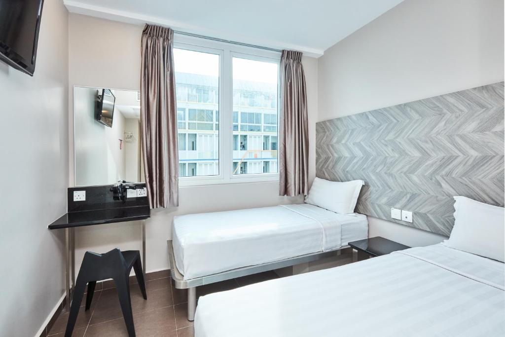 Двухместный (Улучшенный двухместный номер с 2 отдельными кроватями) отеля Fragrance Hotel - Ruby, Сингапур (город)