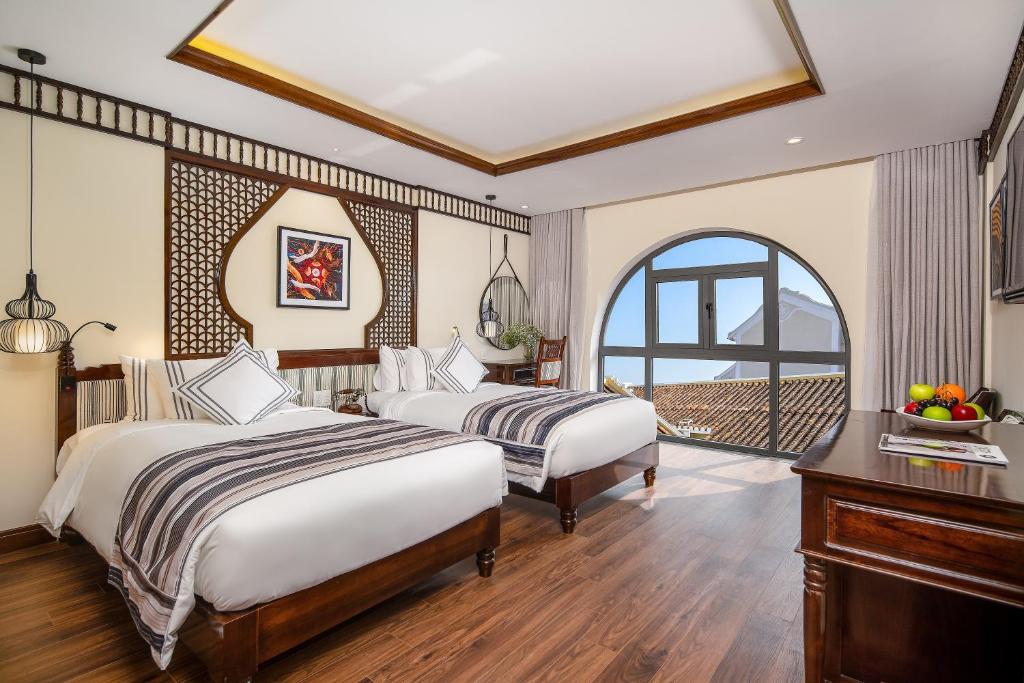 Двухместный (Улучшенный двухместный номер с 2 отдельными кроватями и окном) отеля Le Pavillon Hoi An Paradise Hotel & Spa, Хойан