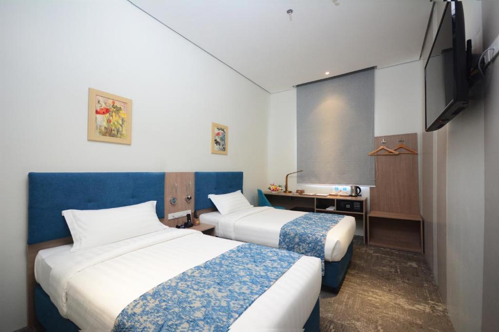 Двухместный (Улучшенный двухместный номер с 2 отдельными кроватями) отеля Blue Lotus Hotel, Давао