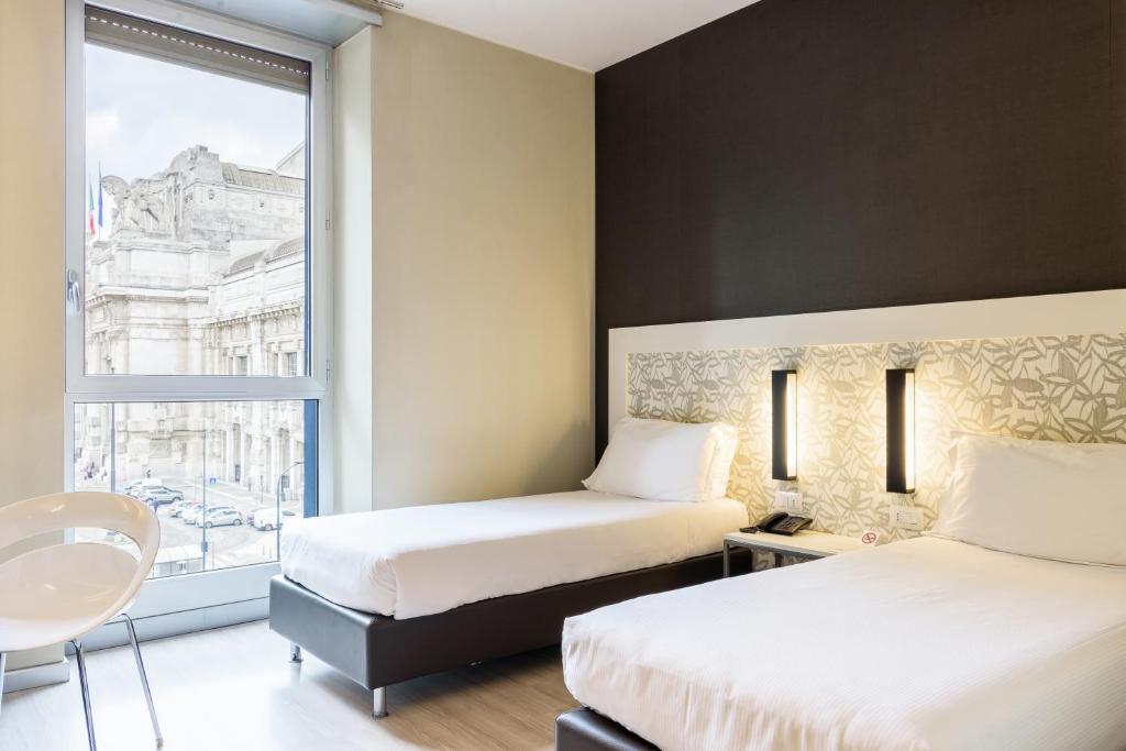 Двухместный (Улучшенный двухместный номер с 2 отдельными кроватями) отеля Hotel Aosta - Gruppo MiniHotel, Милан