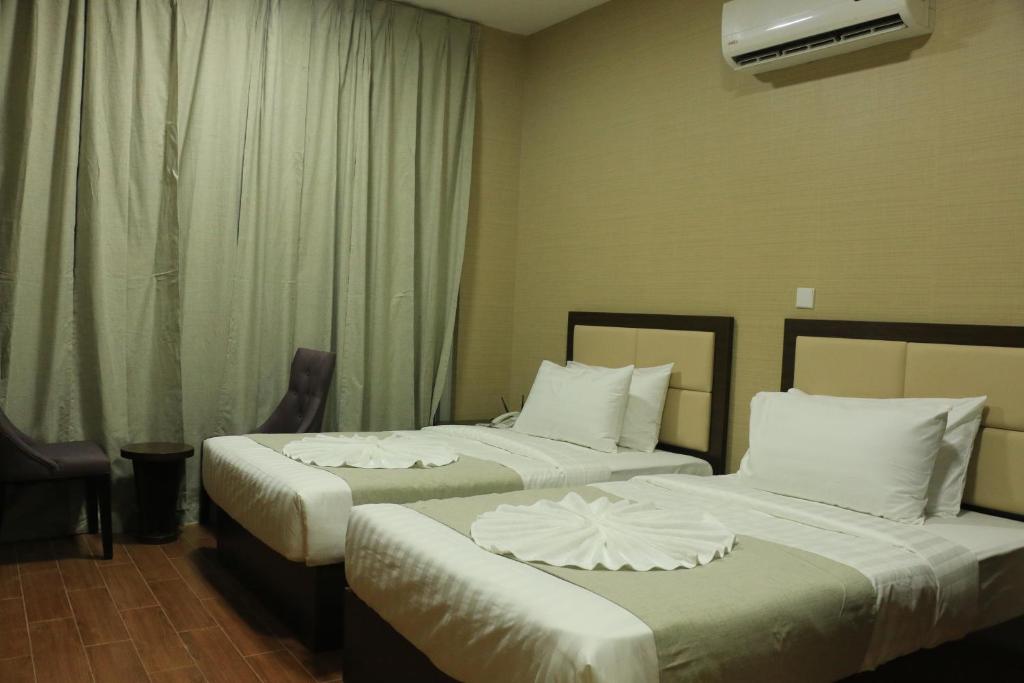 Двухместный (Двухместный номер Делюкс с 1 кроватью или 2 отдельными кроватями) отеля OYO 102 Alpha Suites, Салала