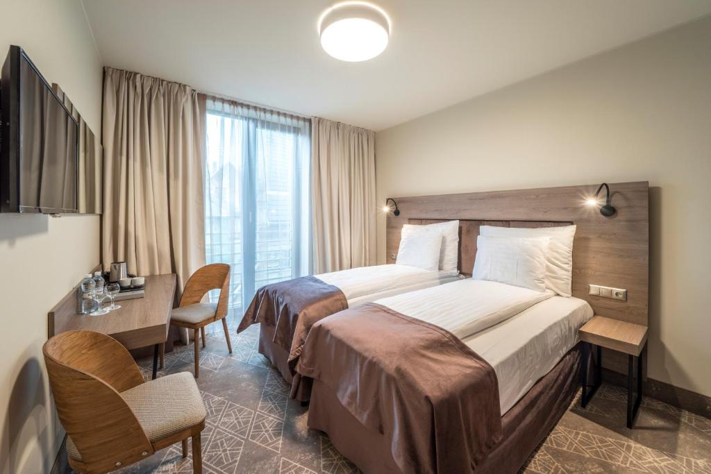Двухместный (Стандартный двухместный номер с 1 кроватью или 2 отдельными кроватями и доступом в спа-центр) отеля Wellton Riverside SPA Hotel, Рига