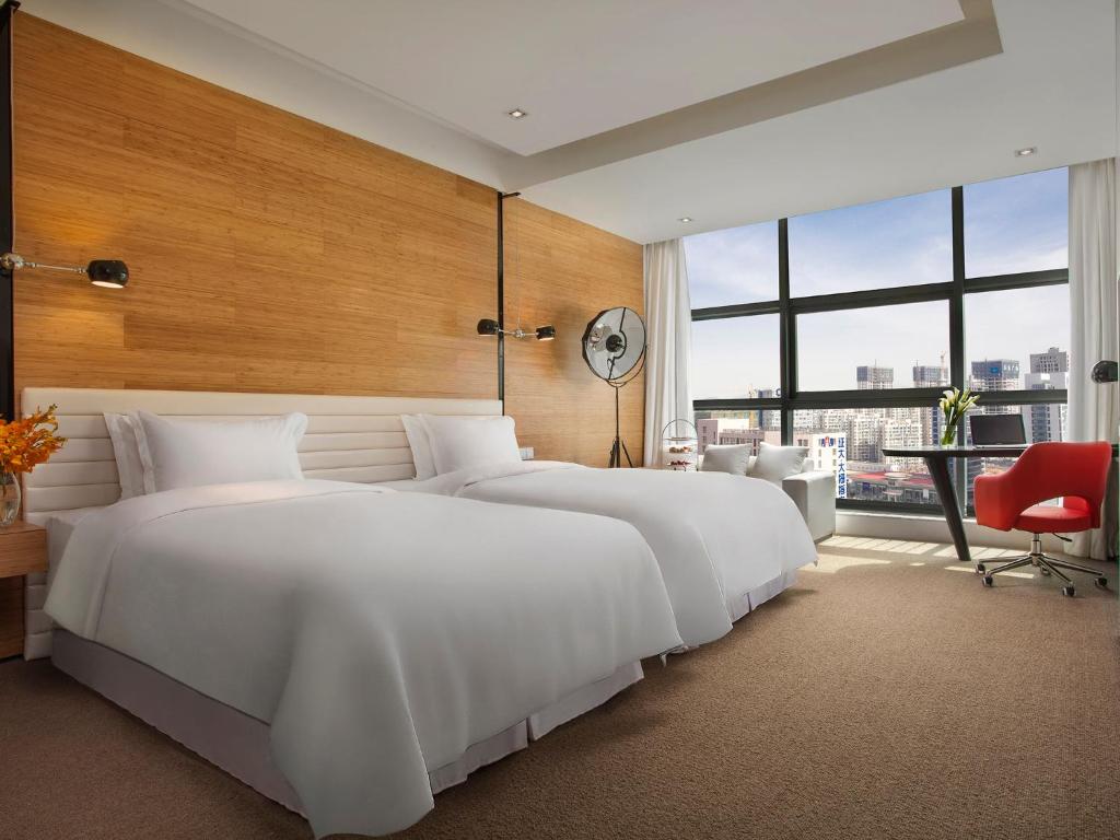 Двухместный (Улучшенный двухместный номер Делюкс с 2 отдельными кроватями - Бесплатный мини-бар) отеля Himalayas Hotel Qingdao, Циндао