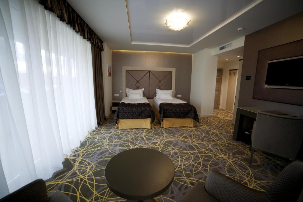 Двухместный (Двухместный номер Делюкс с 1 кроватью или 2 отдельными кроватями) отеля Exclusive Hotel & More, Сибиу