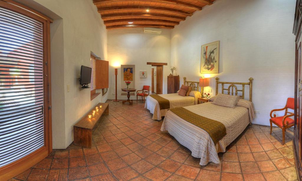 Двухместный (Двухместный номер Делюкс с 2 двуспальными кроватями) отеля Hotel La Casona de Tita, Оахака-де-Хуарес
