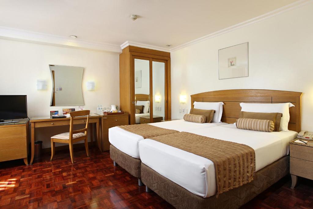 Двухместный (Улучшенный двухместный номер с 2 отдельными кроватями) отеля City Garden Suites, Манила